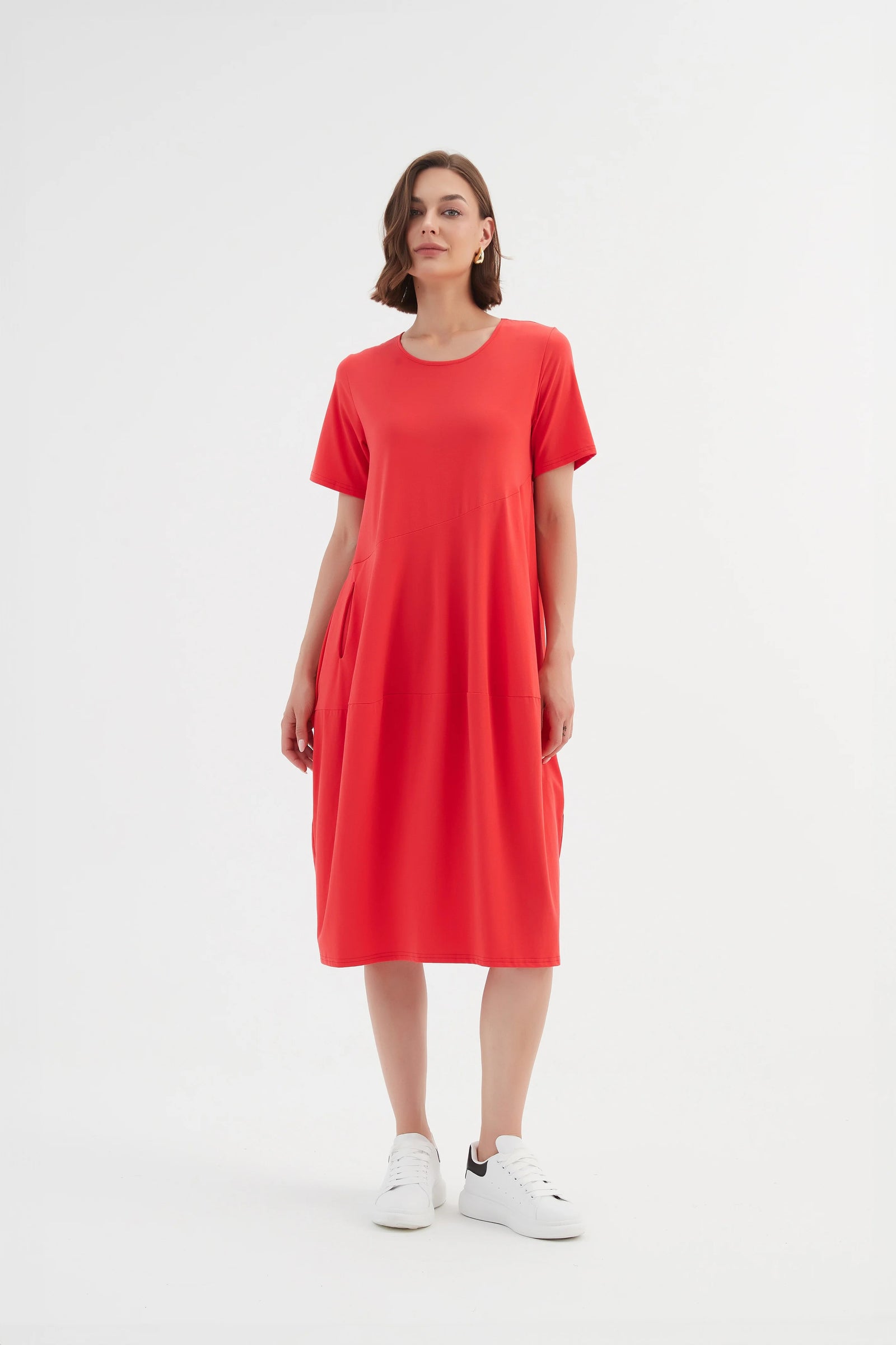 Model wearing Tirelli's Short Sleeve Diagonal Seam Dress in Strawberry Red.