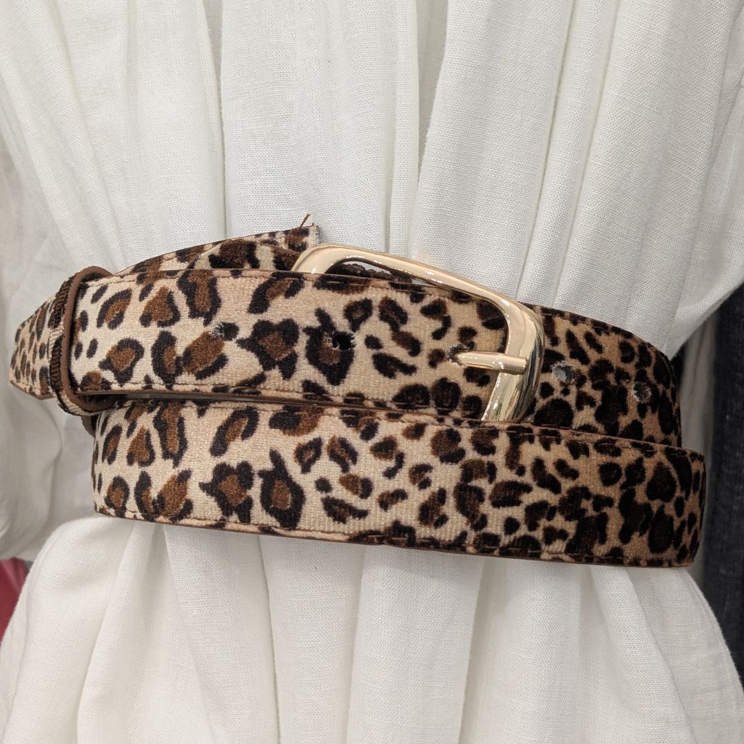 Ladies leopard print belt looped around dress.